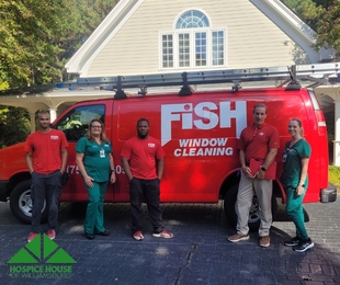 fish employees standing in front of fish van with two nurses