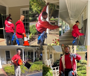 multiple window cleaners helping clean windows and window screens of a building