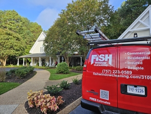 fish window cleaning van parked in front of building