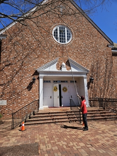 window cleaner cleaning a building's high window