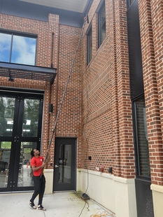 window cleaner cleaning windows of new fire department building
