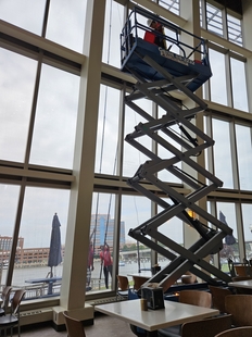 window cleaner cleaning wall of windows