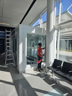 window cleaner cleaning interior side of windows of new amtrak station