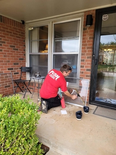 FISH Window Cleaner Cleans Storm Window on Front Porch of Home