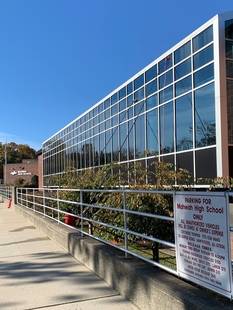 Two Window Cleaners Using Water-Fed Poles to Clean Multi-Story School Windows