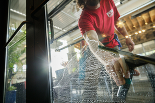 Image of Glass Door Being Cleaned with Squeegee