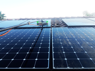 Solar Panels Being Cleaned with Water-Fed Pole