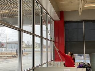 FISH Window Cleaner Using Pole To Clean High Windows of Animal Hospital