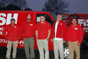 Five Fish Window Cleaning Team Members in Front of Two Branded Vans