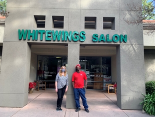 Owner of Whitewings Salon and Fish Window Cleaner Outside of Salon