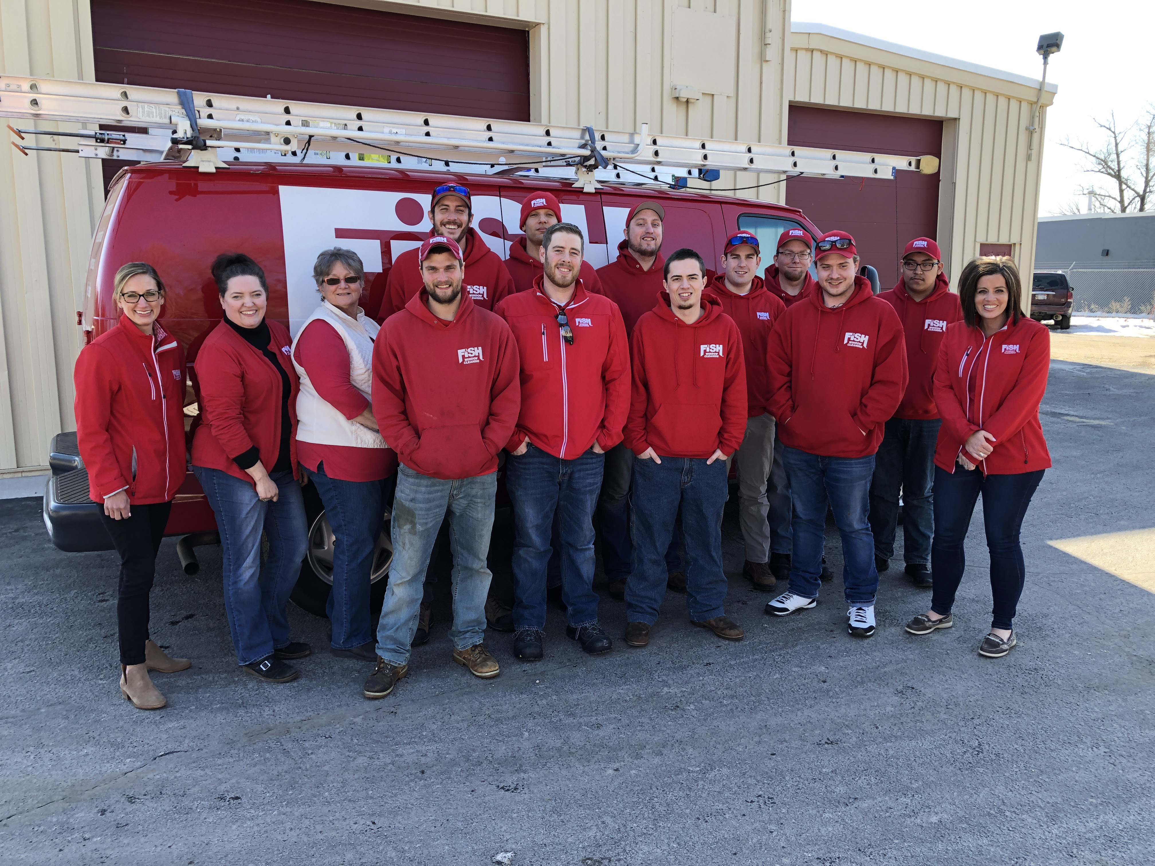 14 Fish Window Cleaning Team Members in Front of Branded Van