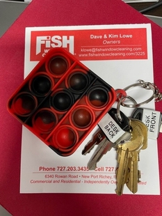 Fish Window Cleaning Document with Key Ring and Red and Black Pop-It