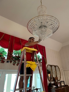 FISH Window Cleaner on Ladder Cleaning Large Crystal Chandelier