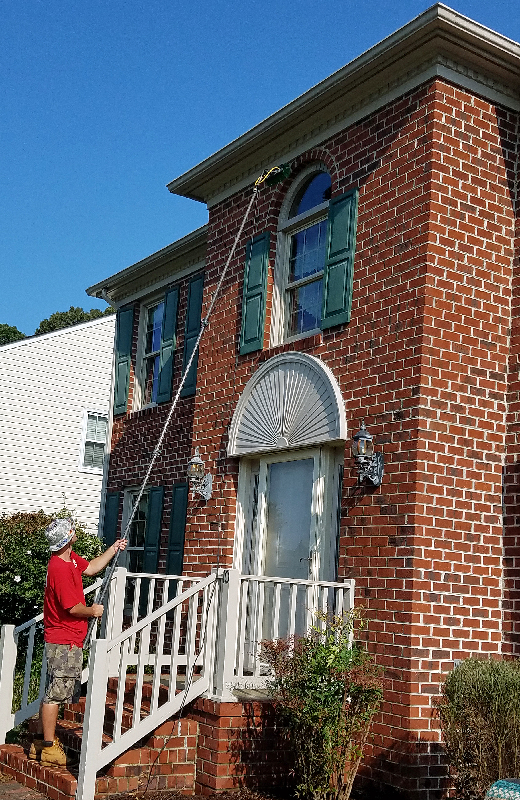 Fish Window Cleaner Cleaning 2nd Story Foyer Window with a Water-Fed Pole