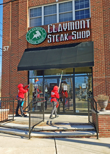 Two Fish Window Cleaning Employees Cleaning Claymont Steak Shop's Windows