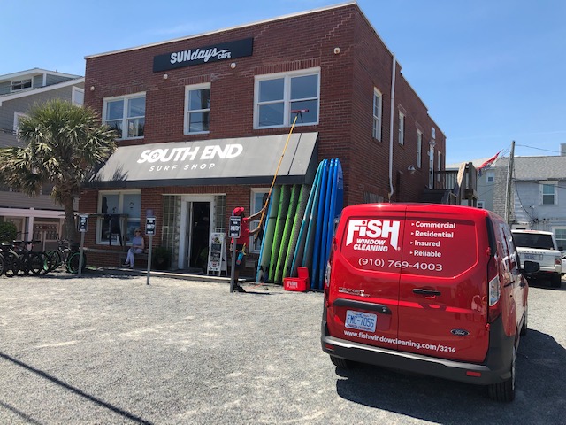 Fish Window Cleaning Branded Van in Front of South End Surf Shop