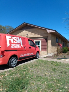 FISH Van and Fish Window Cleaner In Front Of Local Health Clinic