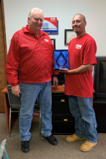 owner roger stanfill posing with fish employee