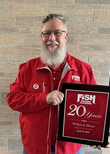 fish employee with his 20 years plaque